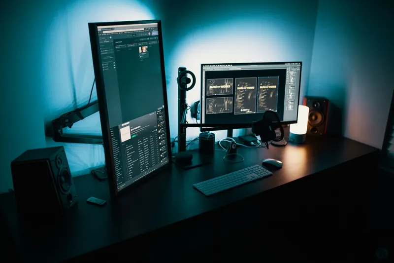 A tidy desk with two monitors and a keyboard